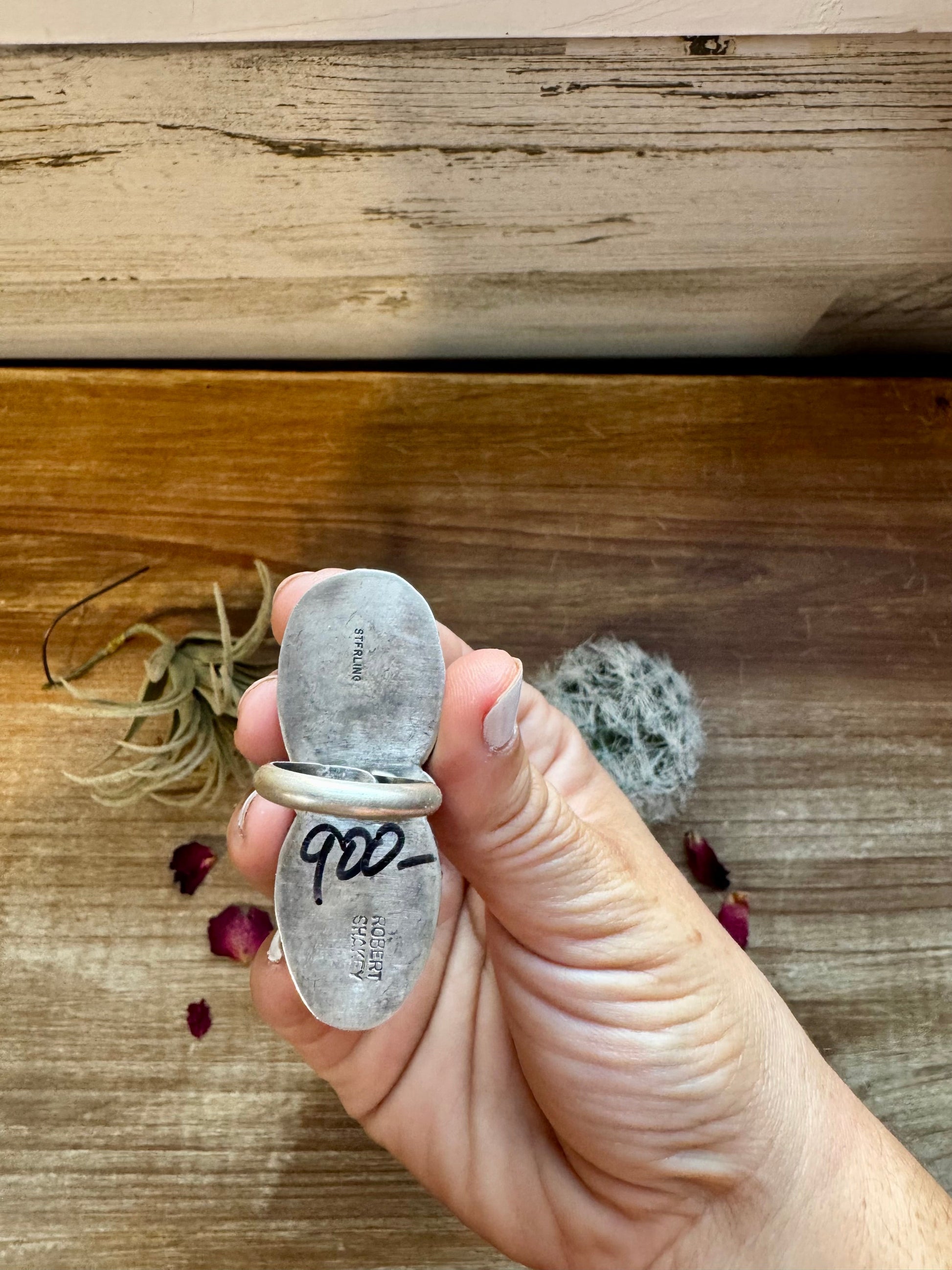 Sterling silver ring held in hand