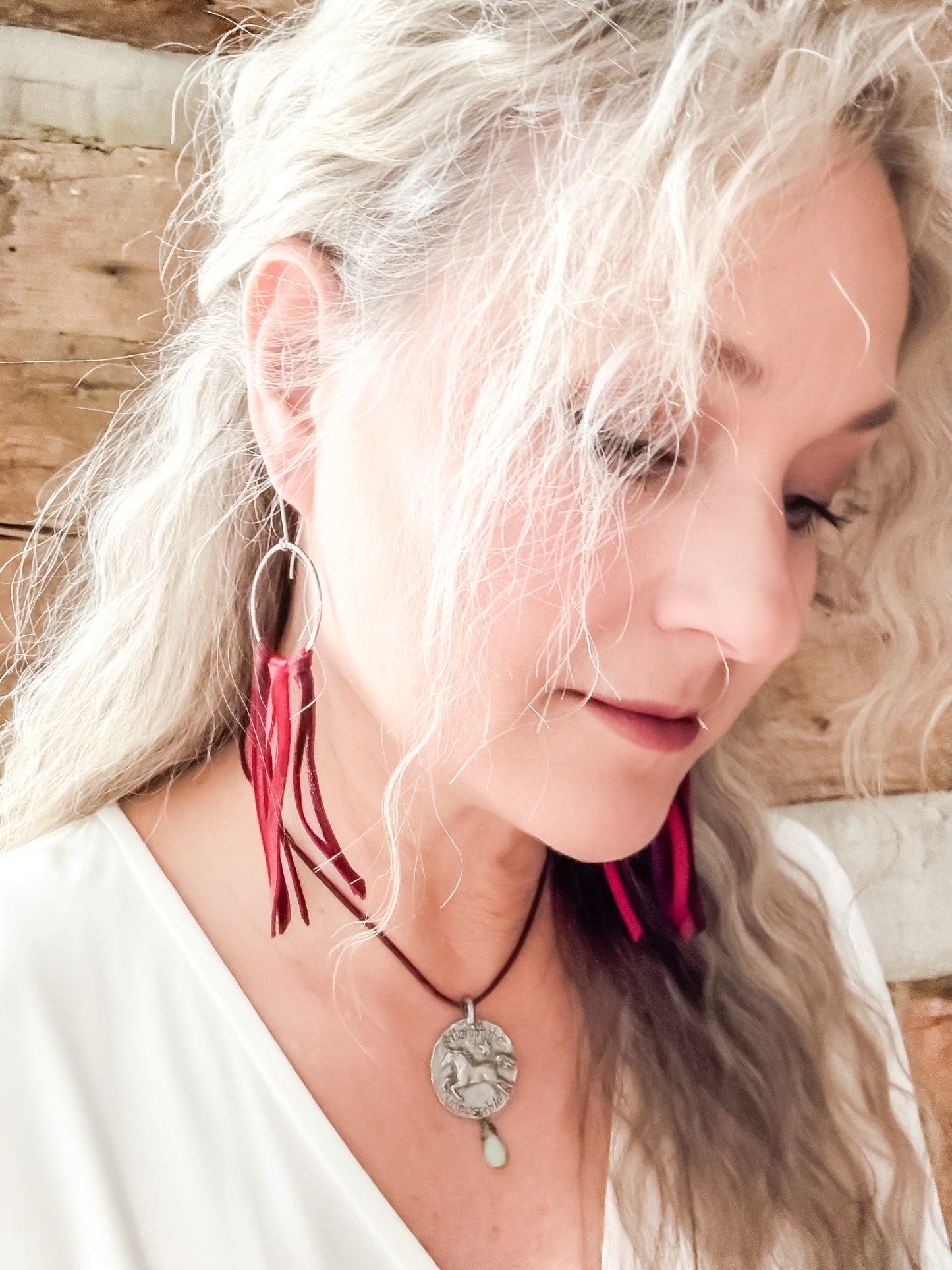 Woman wearing red leather earrings and necklace, Facetune 08-01-2024