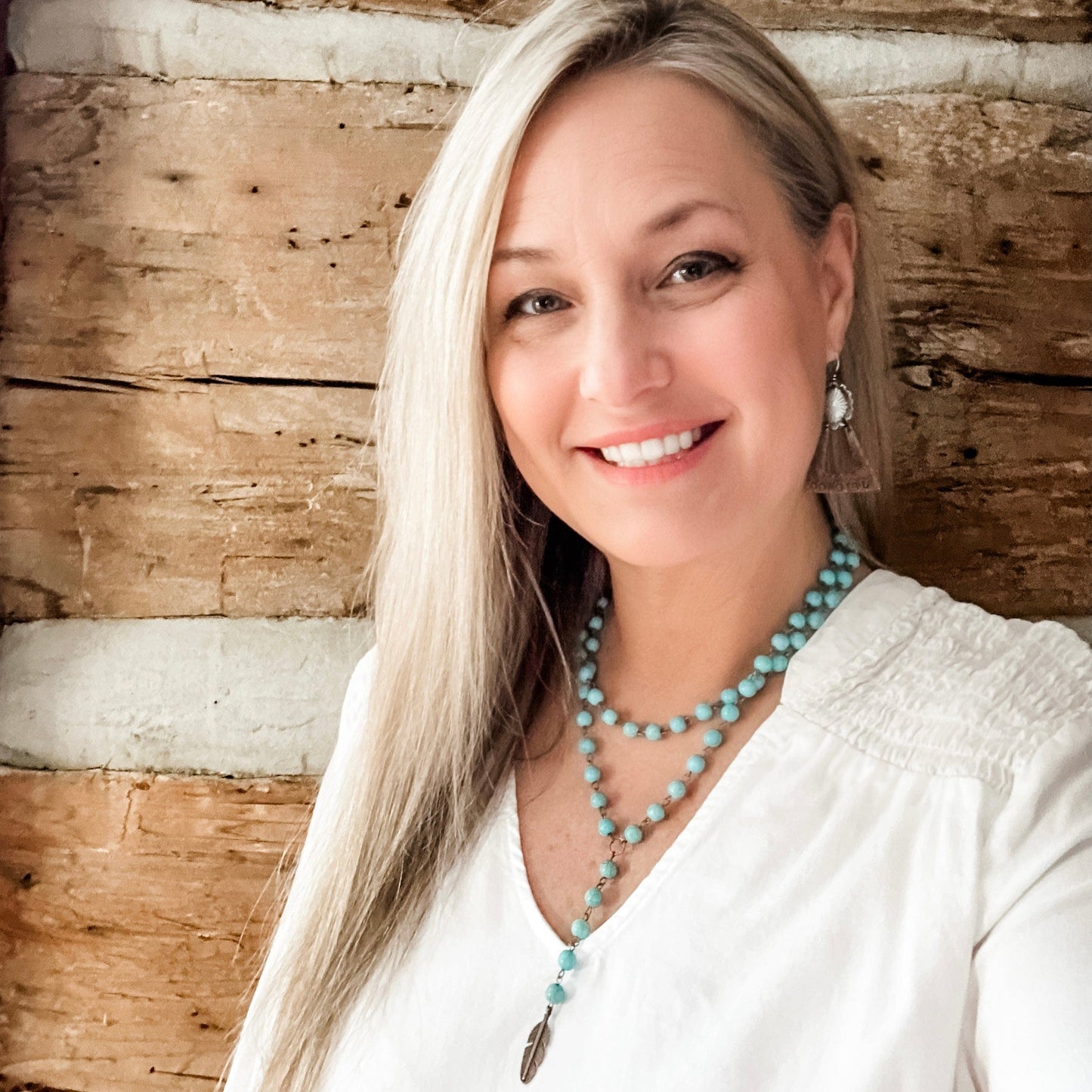 Woman smiling, edited photo, turquoise necklace