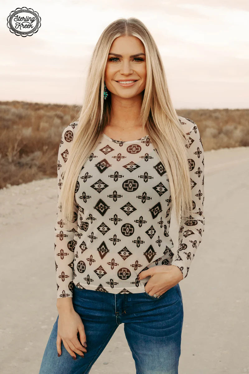 Woman wearing patterned top and jeans
