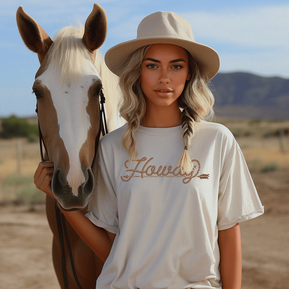 Woman with horse wearing Howdy tee and hat