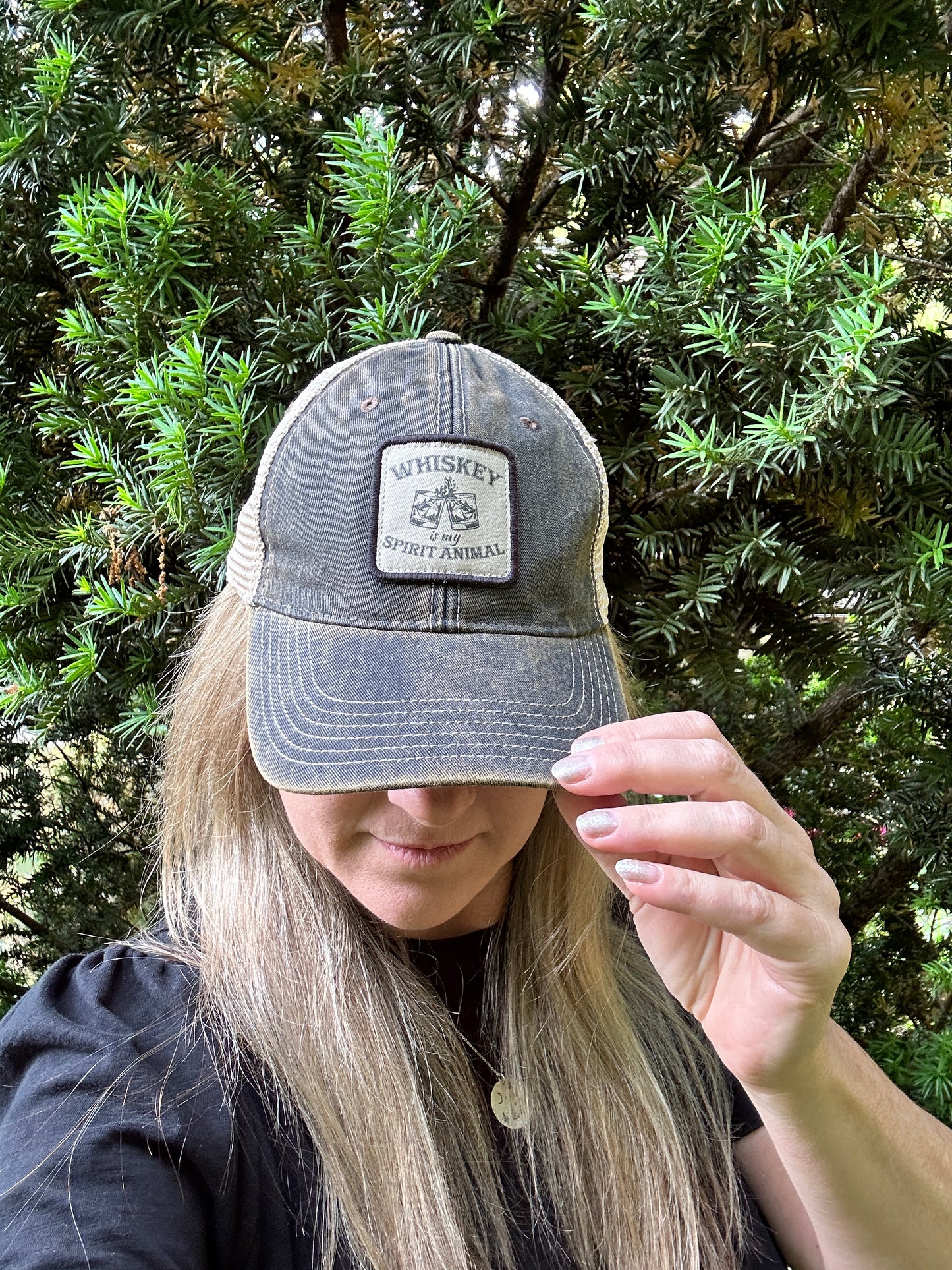 Woman wearing a Whiskey Spirit Animal baseball cap.