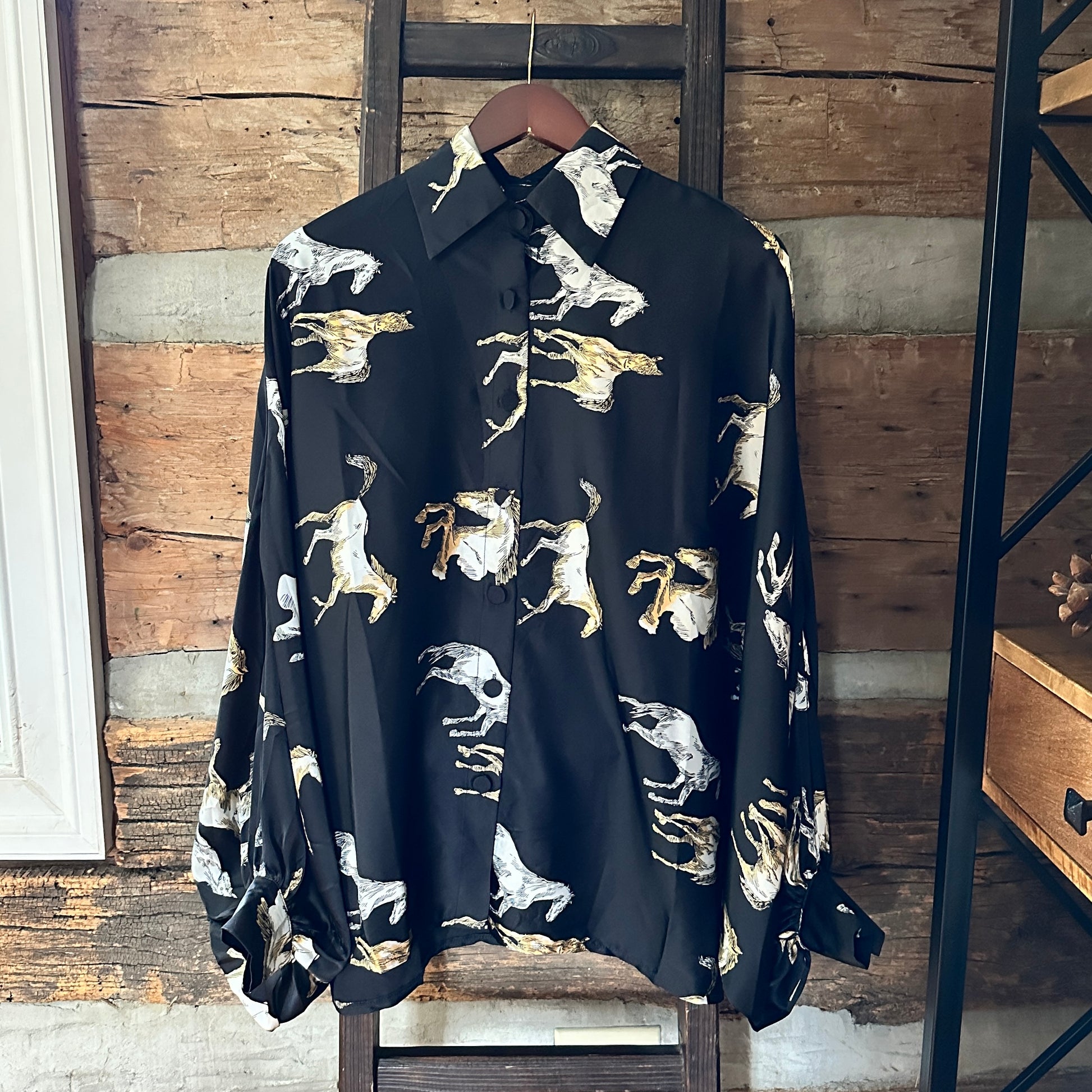 Black shirt with white horse print.