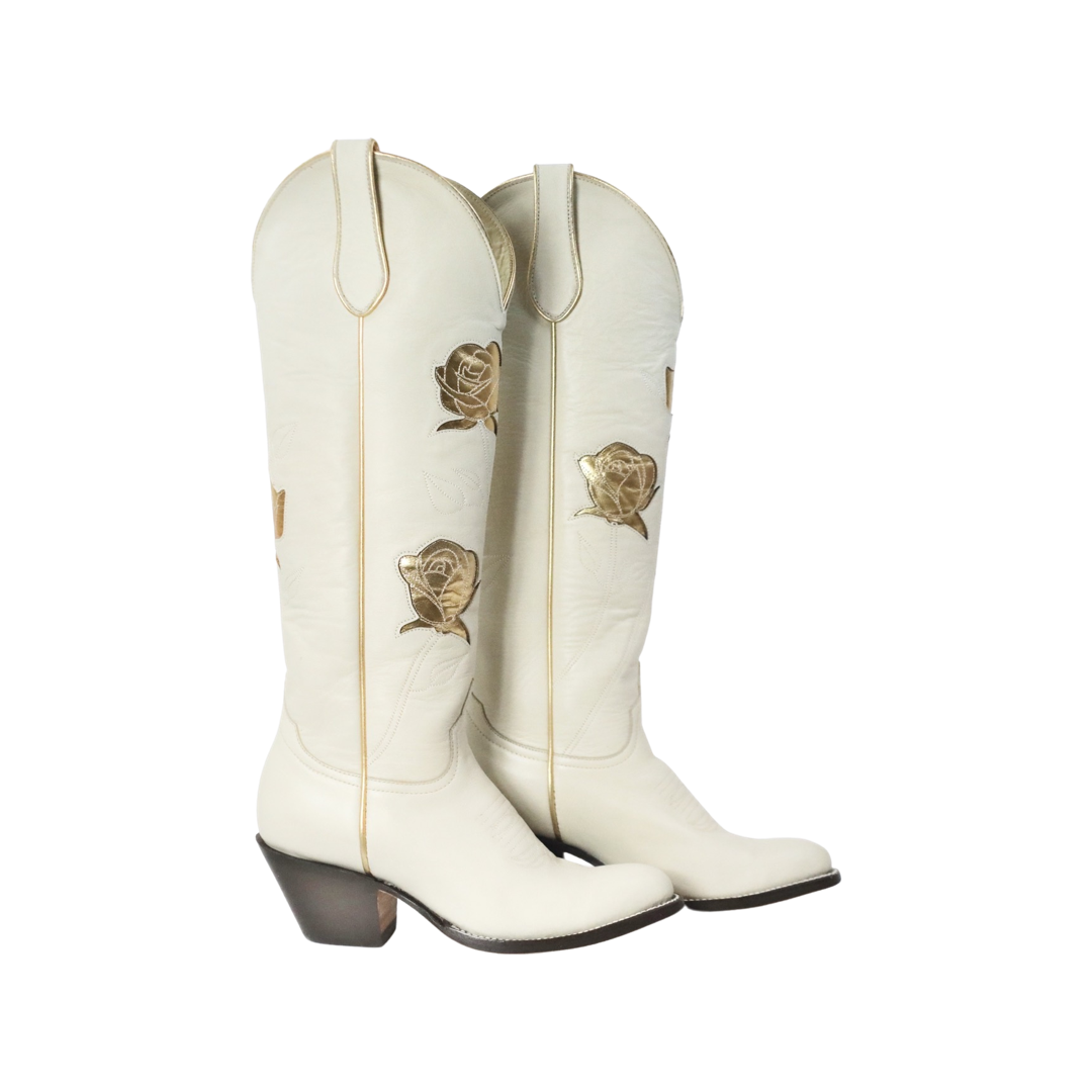 White cowboy boots with gold rose details.