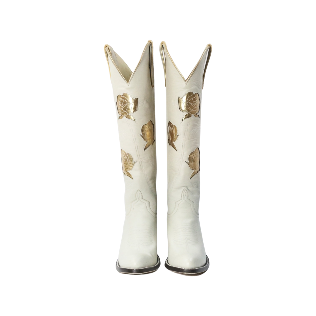 Pair of cream cowboy boots with gold rose details.