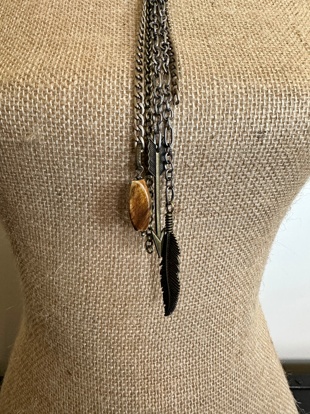 Necklace with feather and stone pendants.