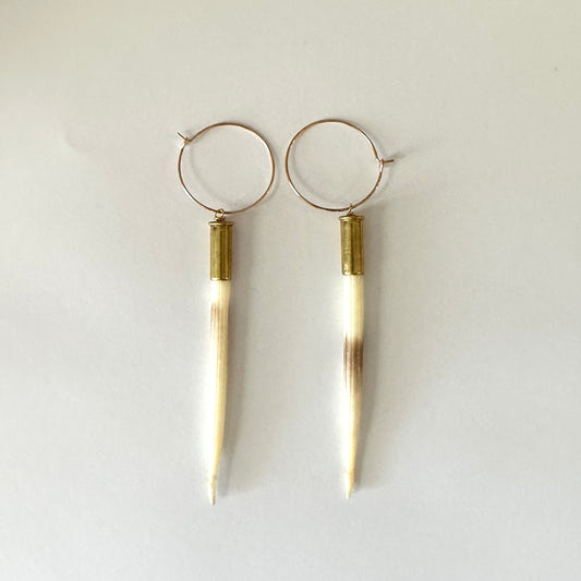 Pair of hoop earrings with long, white pendant.