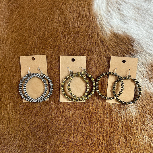 Three pairs of beaded hoop earrings.