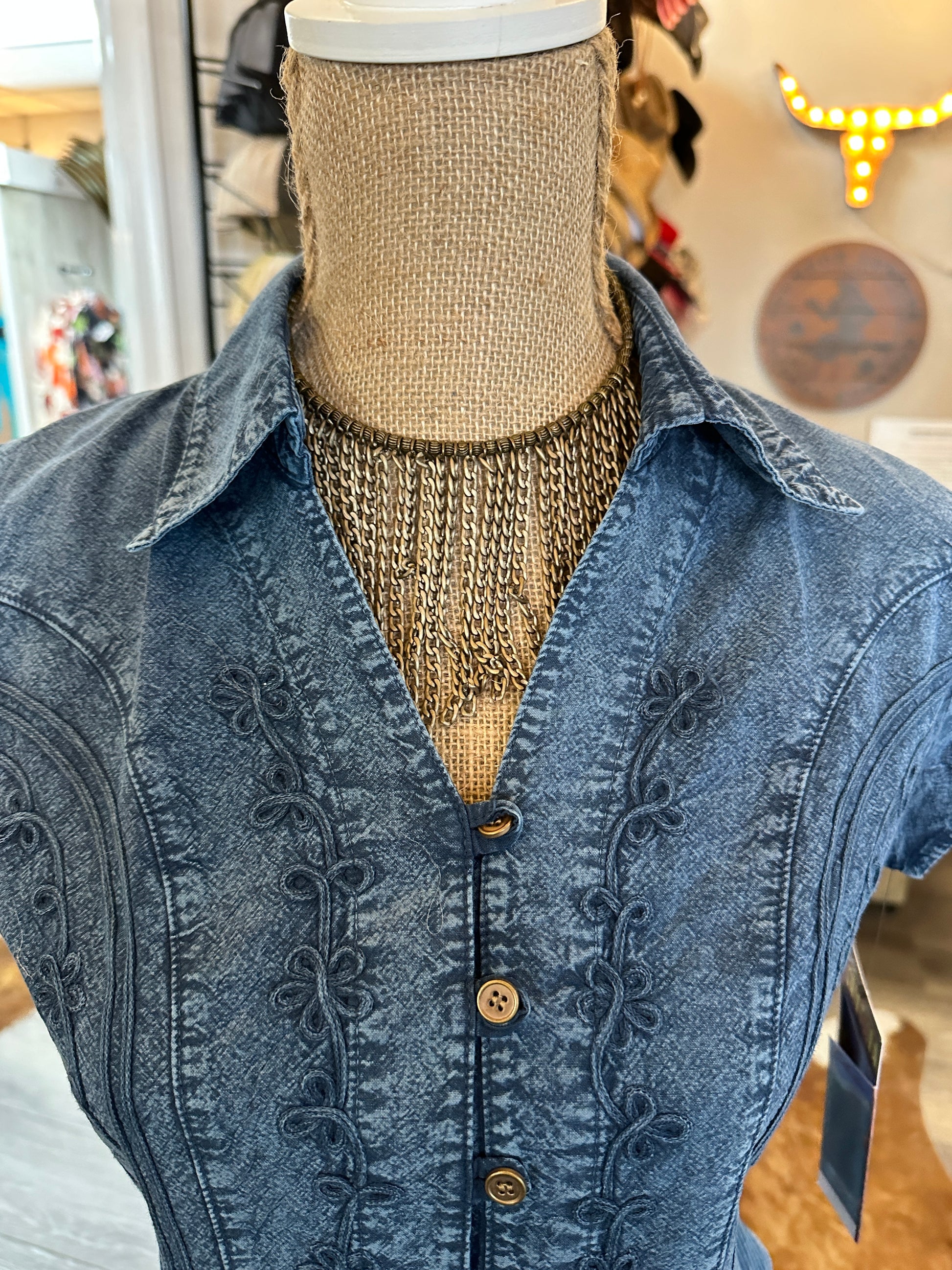 Blue denim shirt on a mannequin.