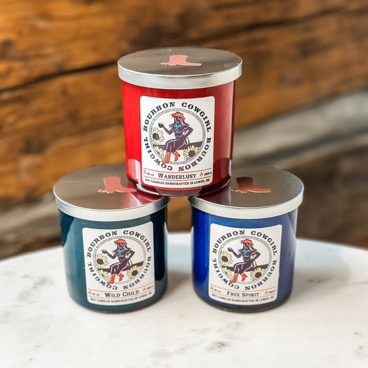 Three labeled candles stacked on a table.