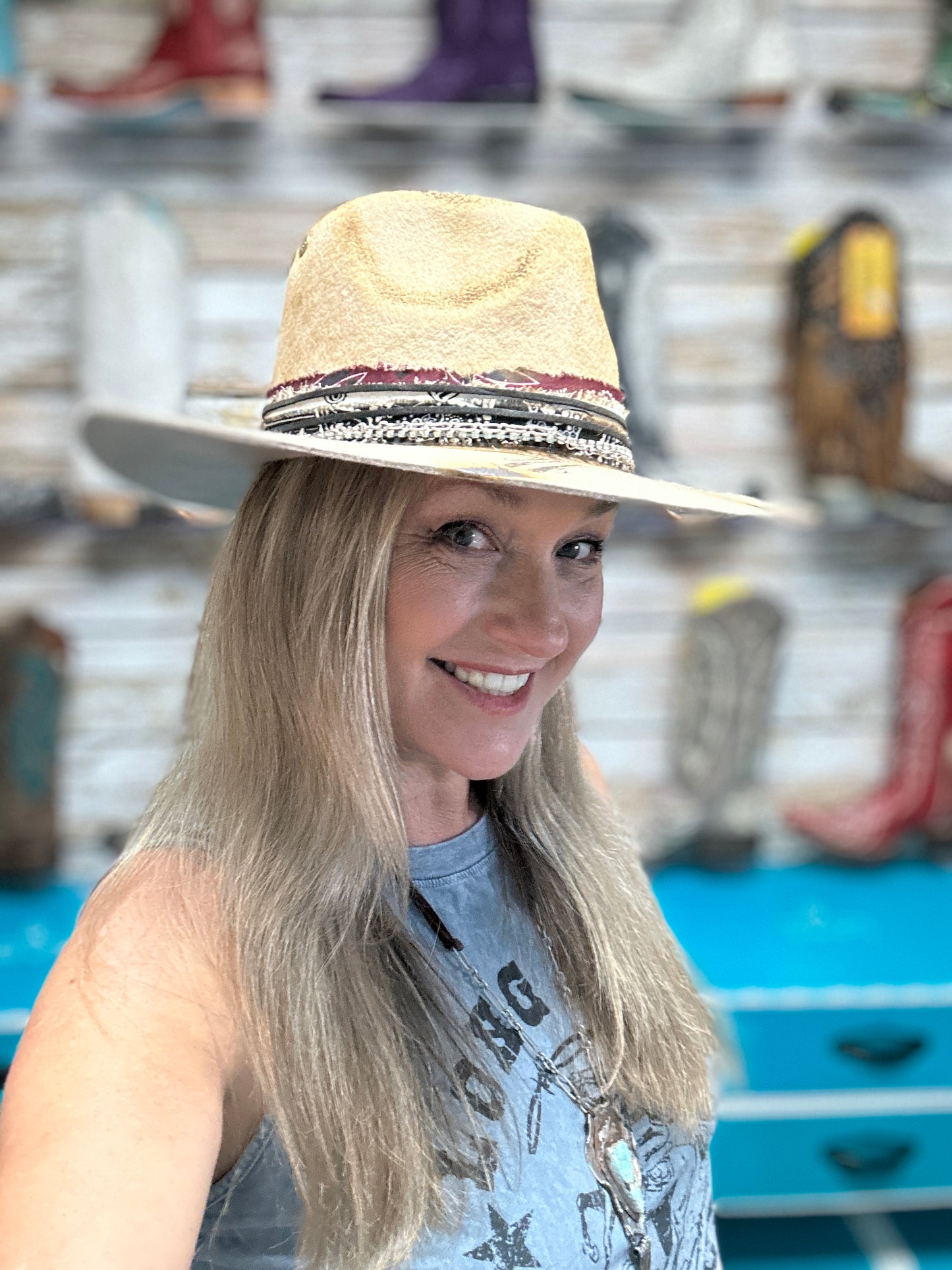 Woman wearing a straw hat and smiling.