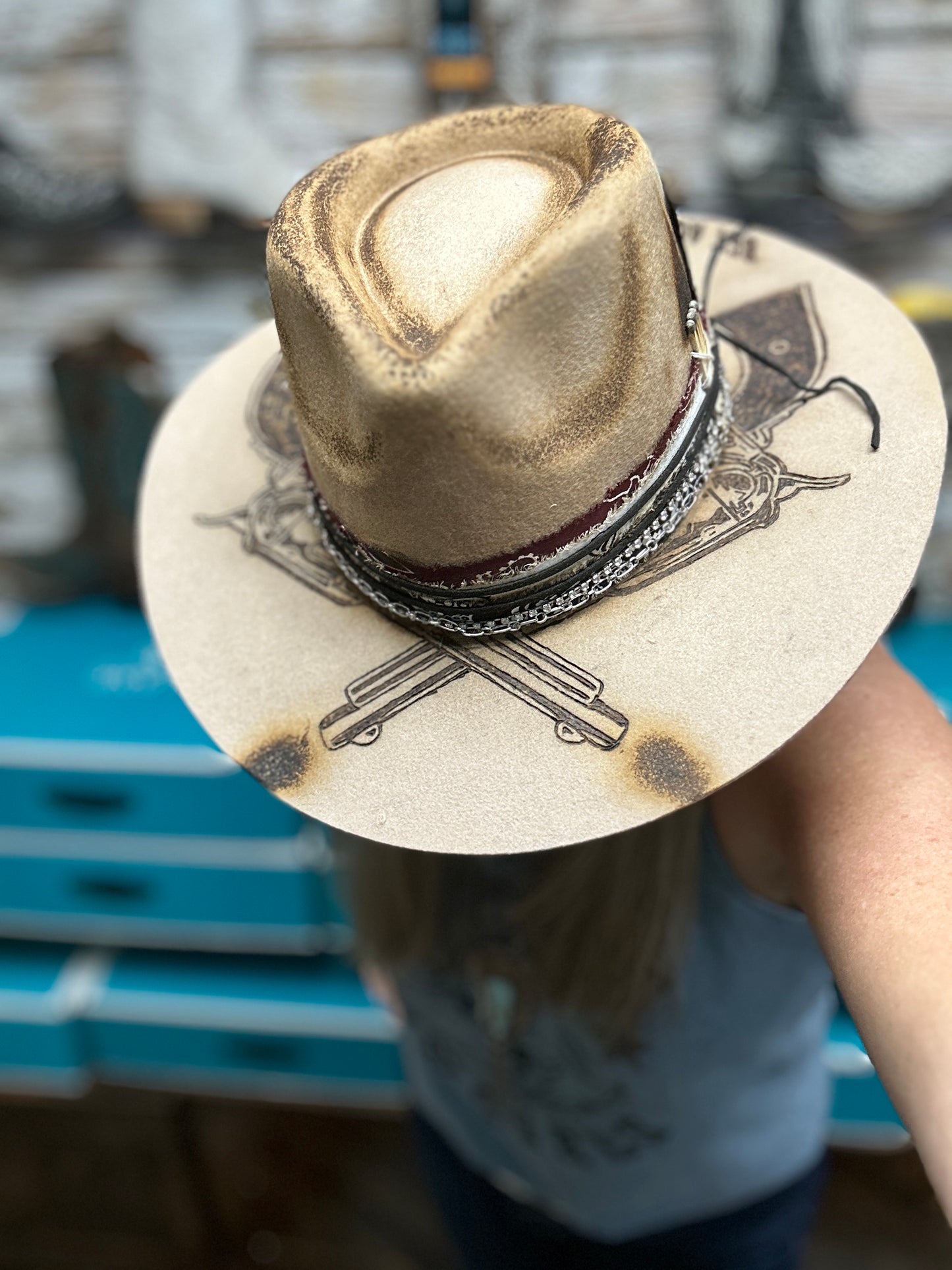 Tan cowboy hat with decorative brim.