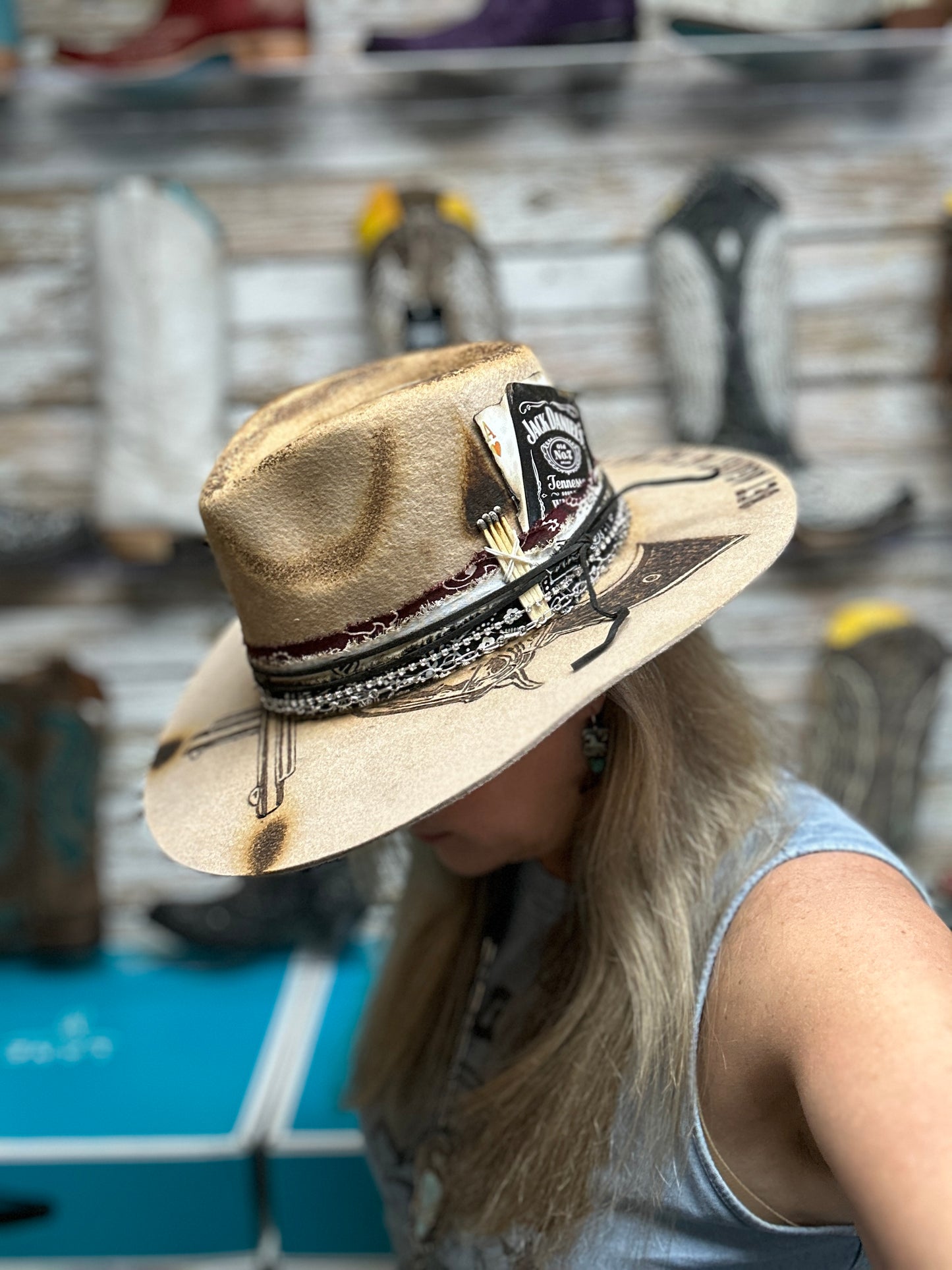 Woman wearing a decorated cowboy hat.