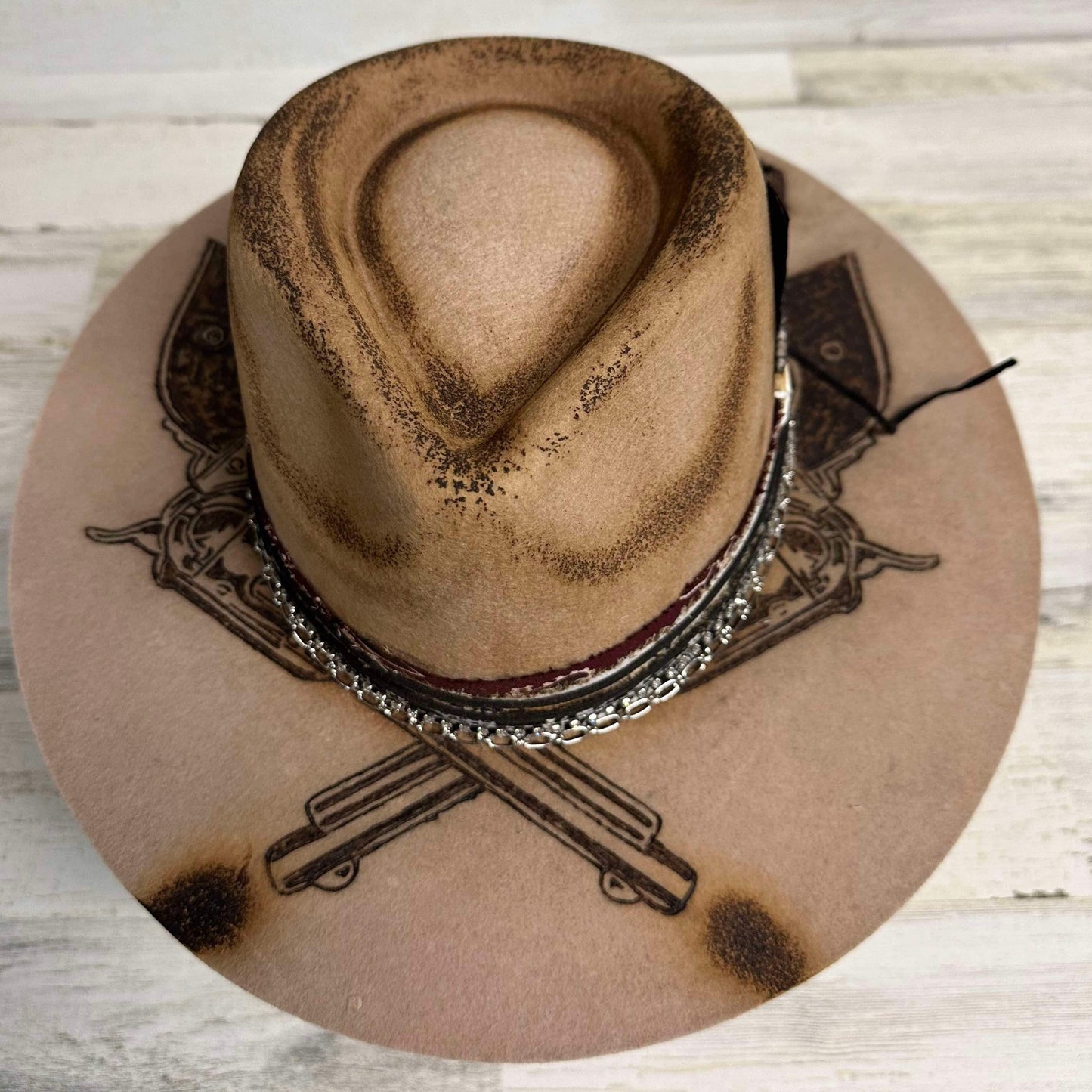 Tan cowboy hat with etched design.