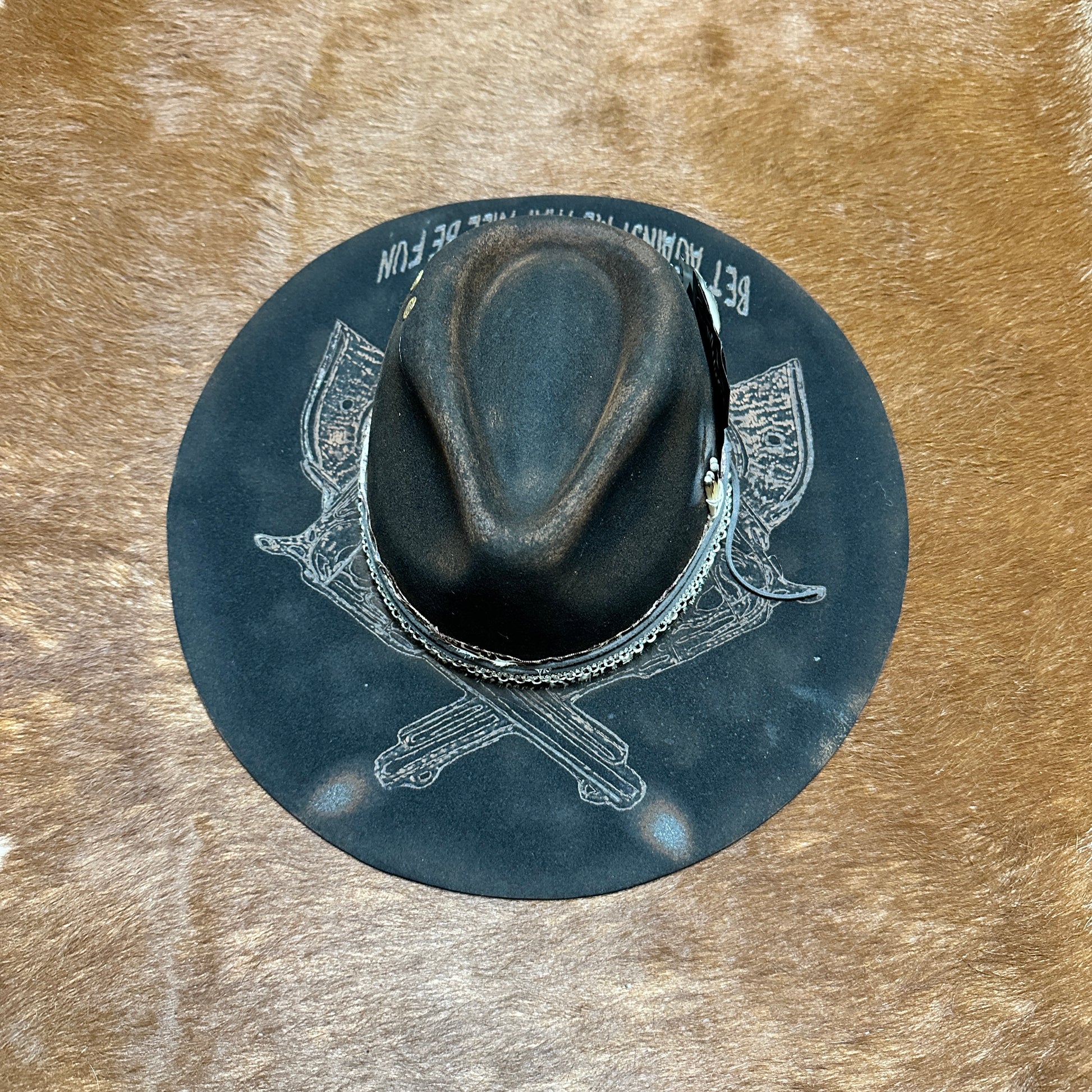Dark fedora hat on a brown surface.