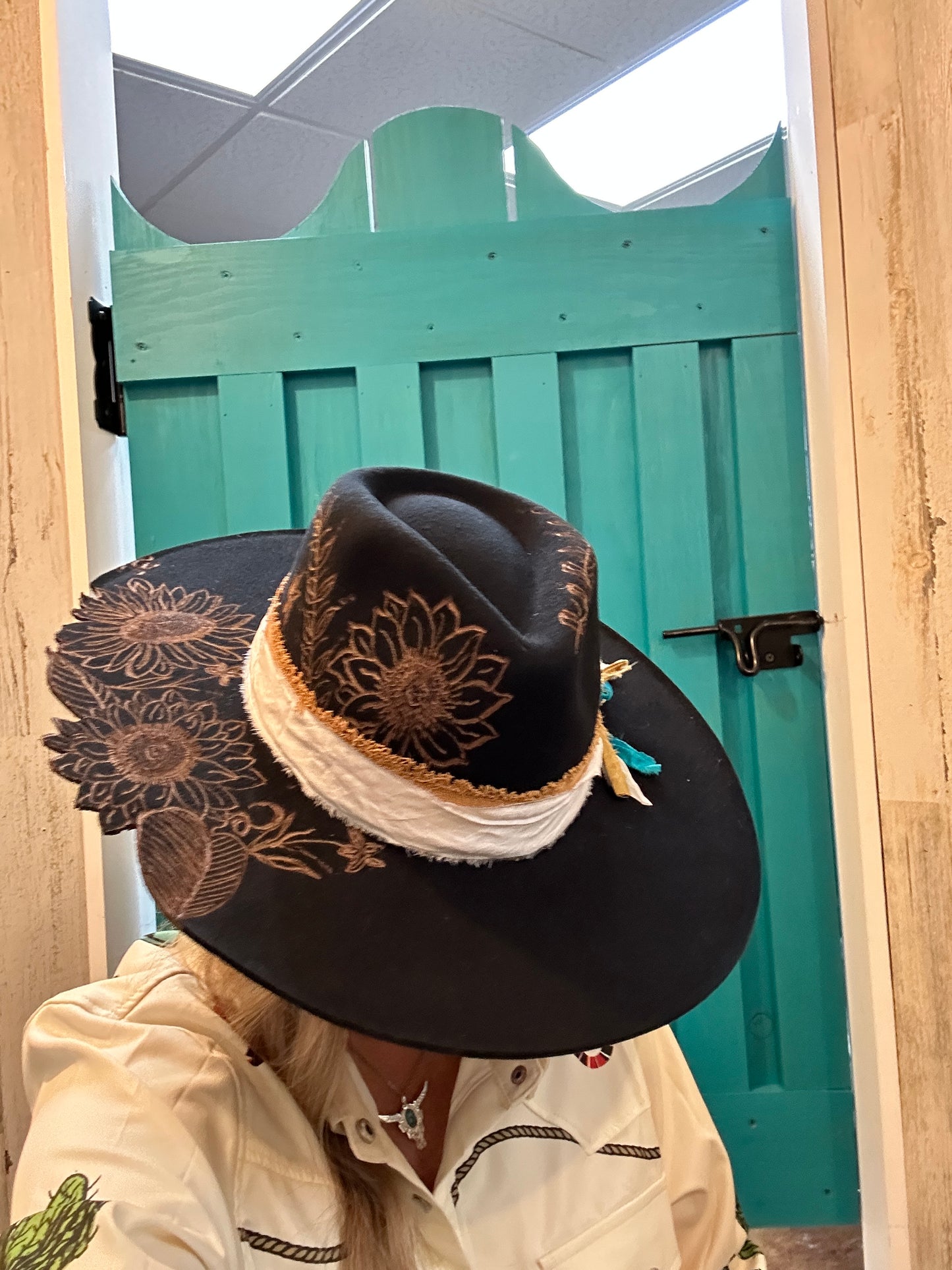 Black hat with sunflower design.