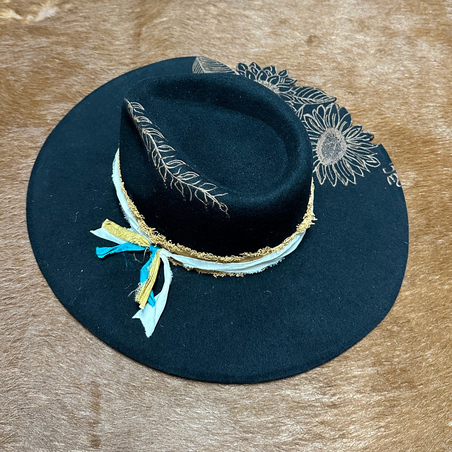 Black hat with floral design and ribbon.