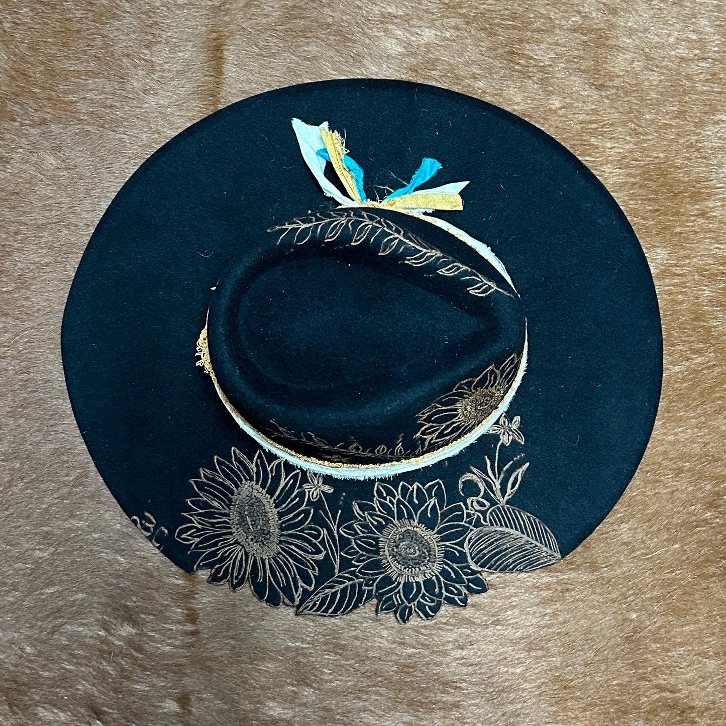 Black hat with gold sunflower design.