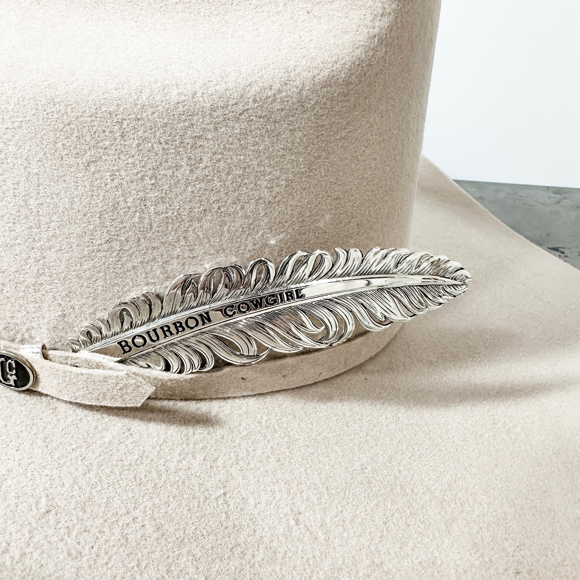 Cowboy hat with feather detail.