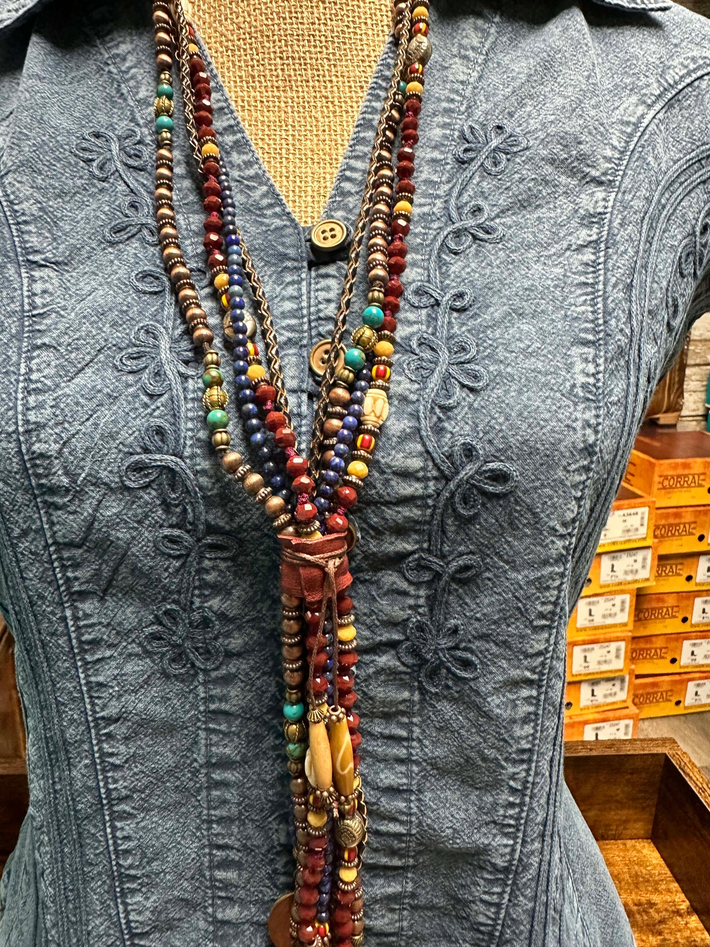 Necklace on denim shirt.