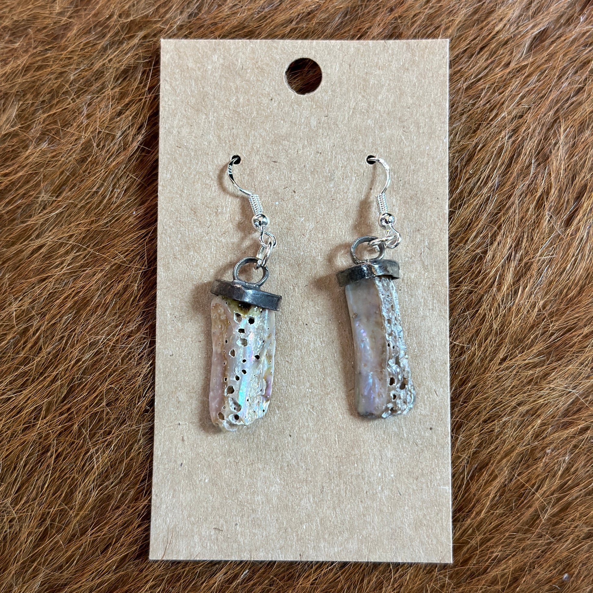 Earrings on a cardboard display.