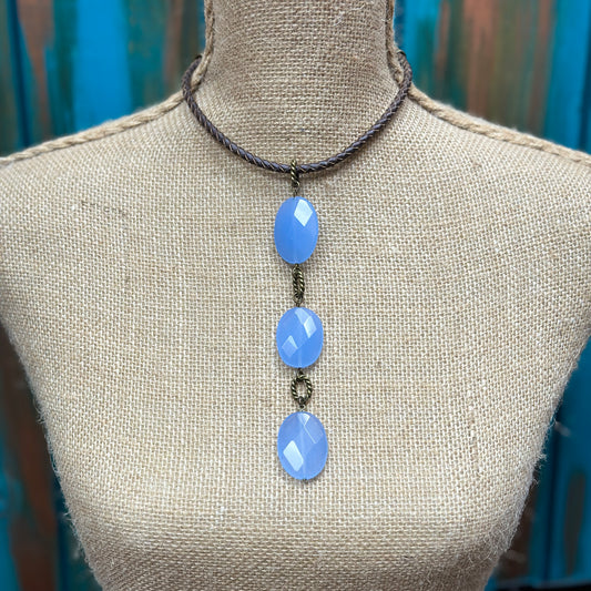 Necklace with three blue oval stones.