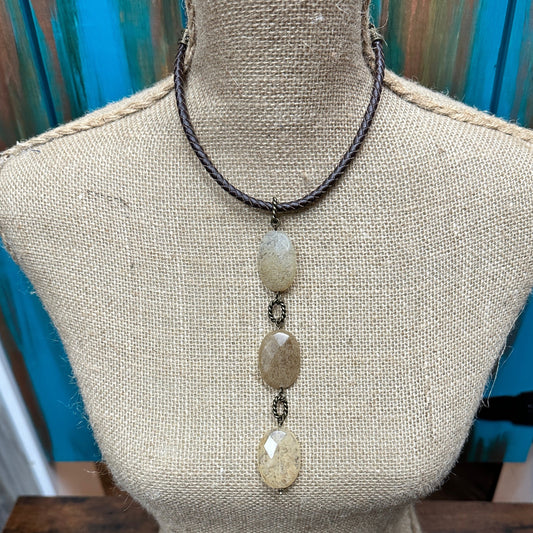 Necklace with three stone pendants on a braided cord.