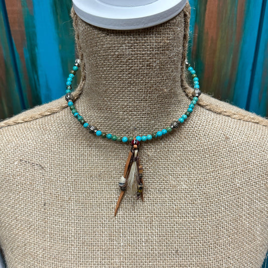 Turquoise beaded necklace on a mannequin.