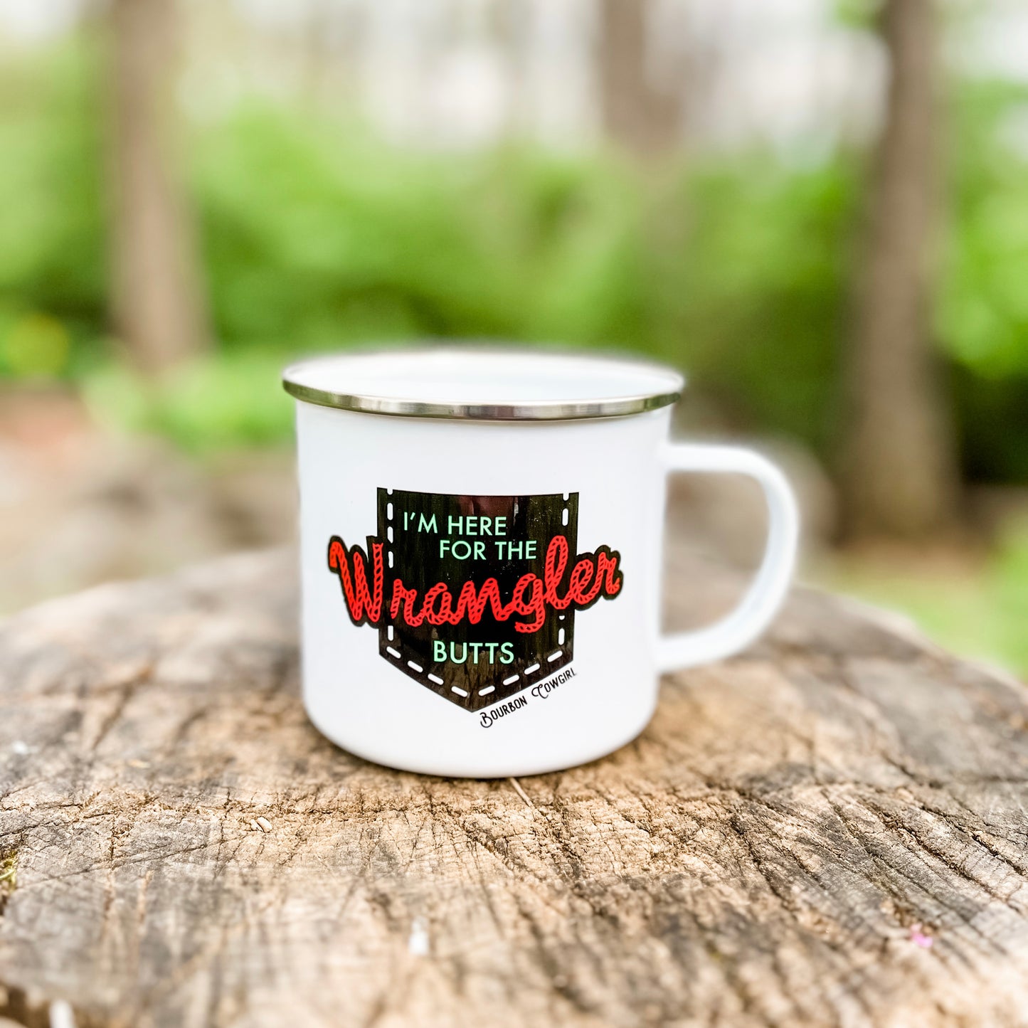 White mug with I'm here for the Wrangler butts on a wood surface.