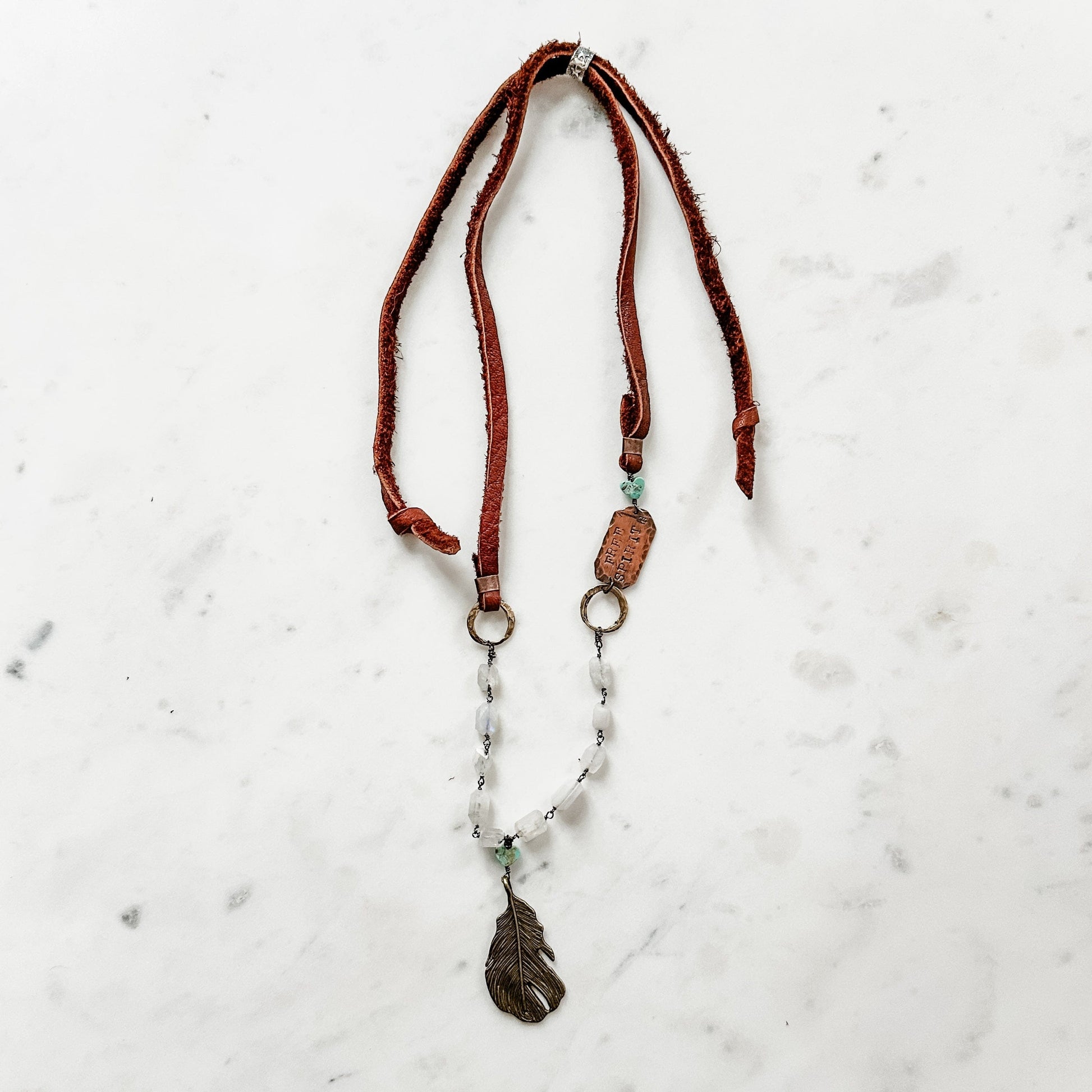Leather and beaded necklace with feather pendant.