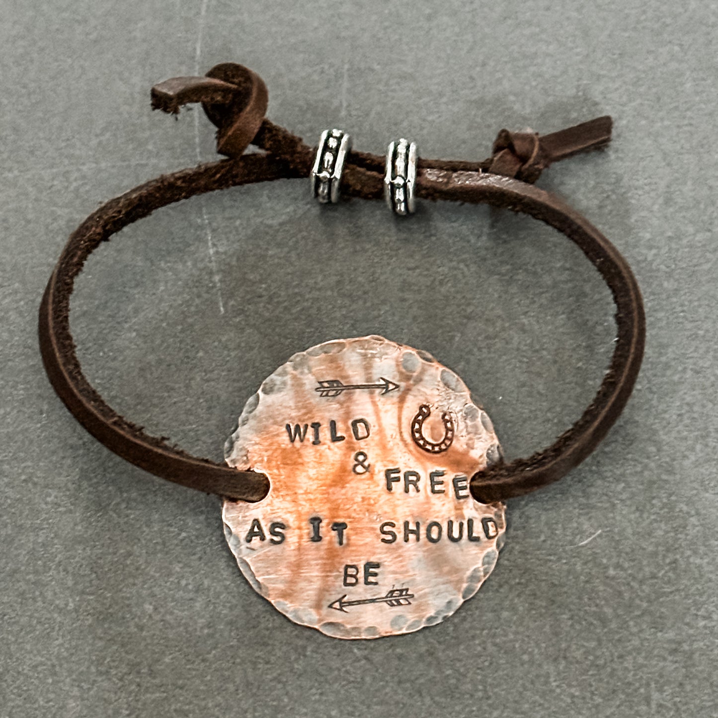 Leather bracelet with Wild & Free charm.