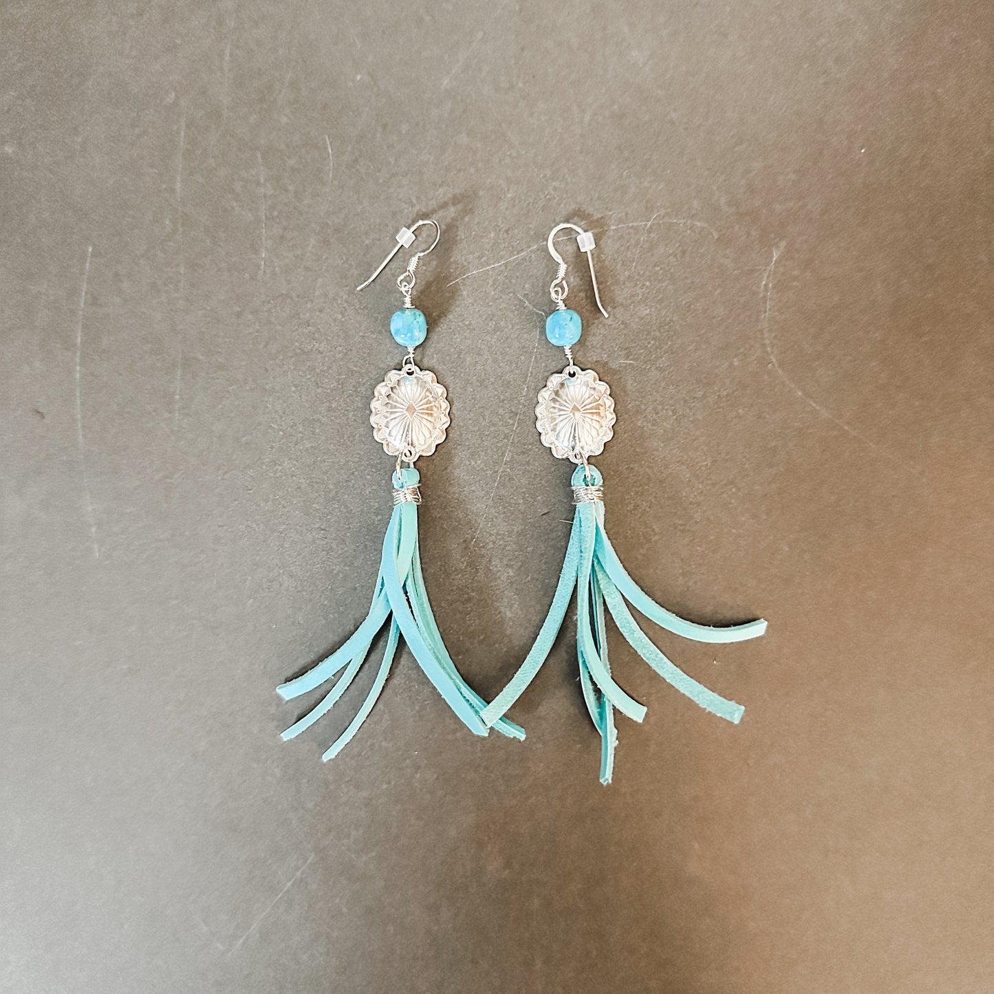 Turquoise tassel earrings.