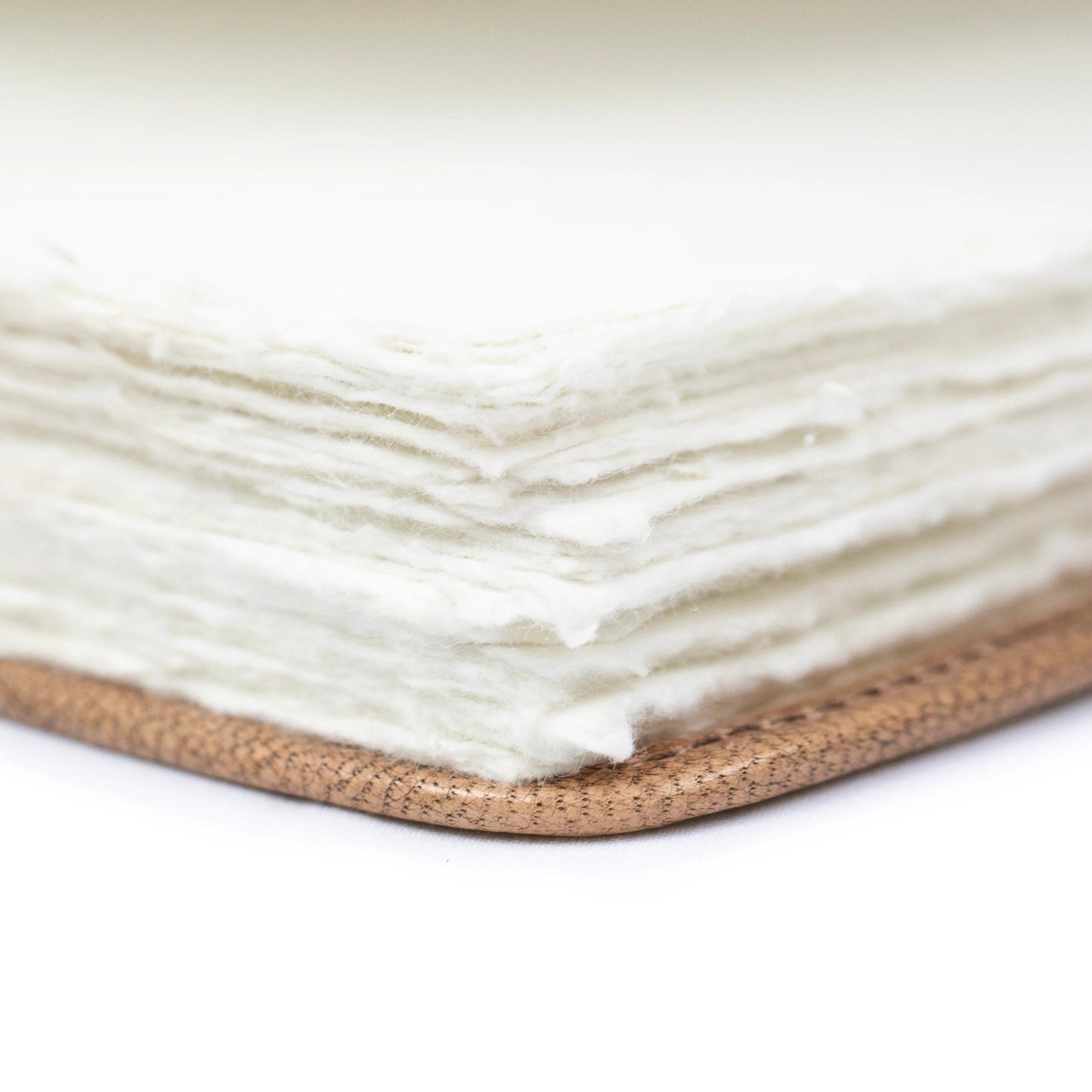 close-up of textured paper pages and leather binding