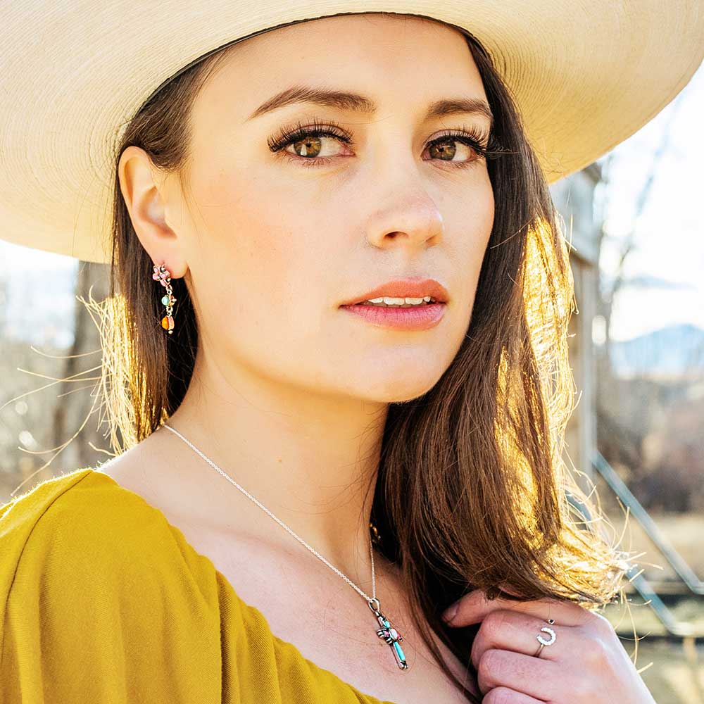 Woman in hat with earrings and necklace