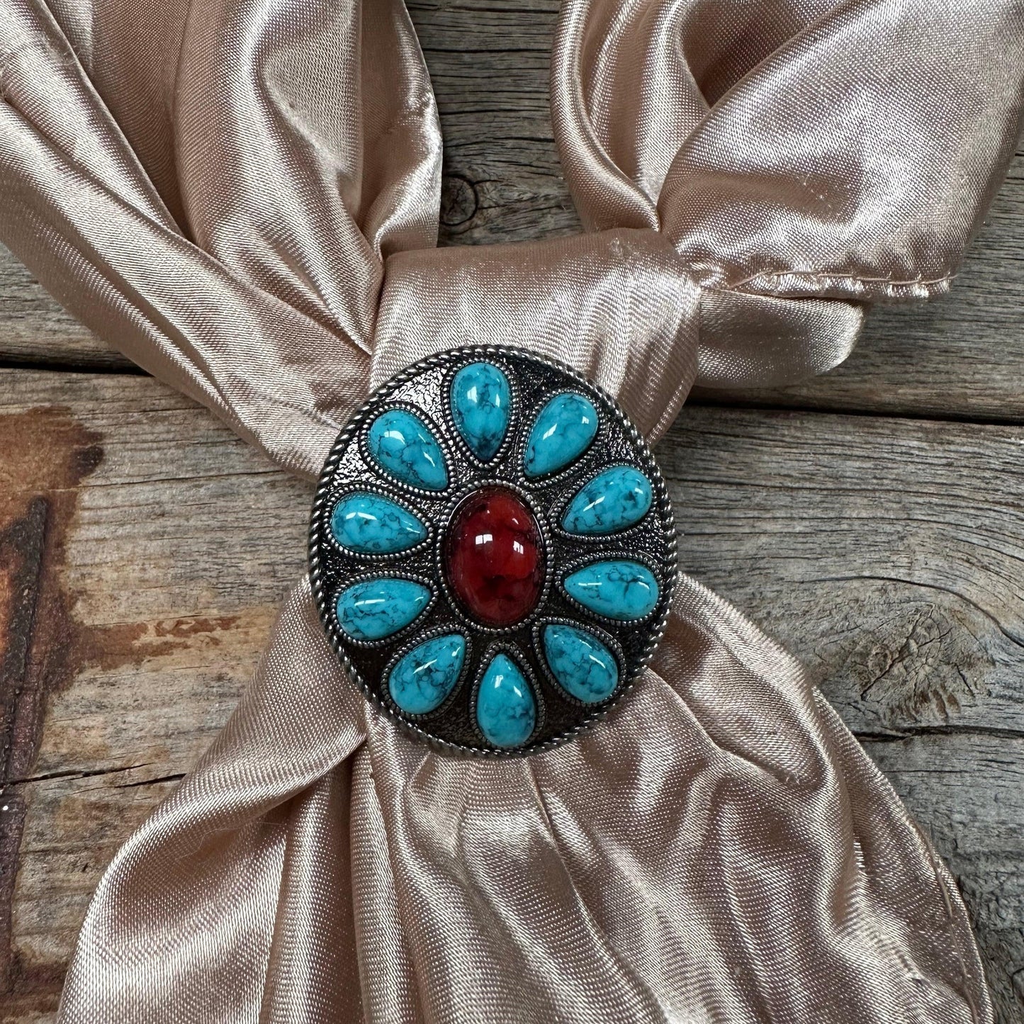 Turquoise and red stone scarf slide on beige scarf.
