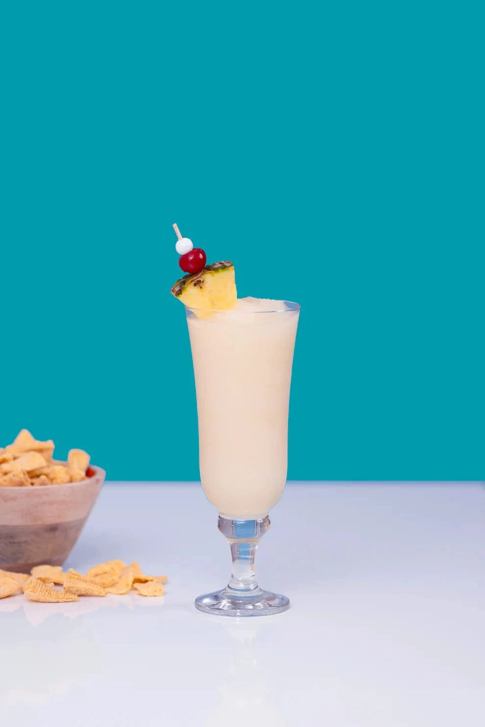 Pina Colada cocktail with cherry and pineapple garnish