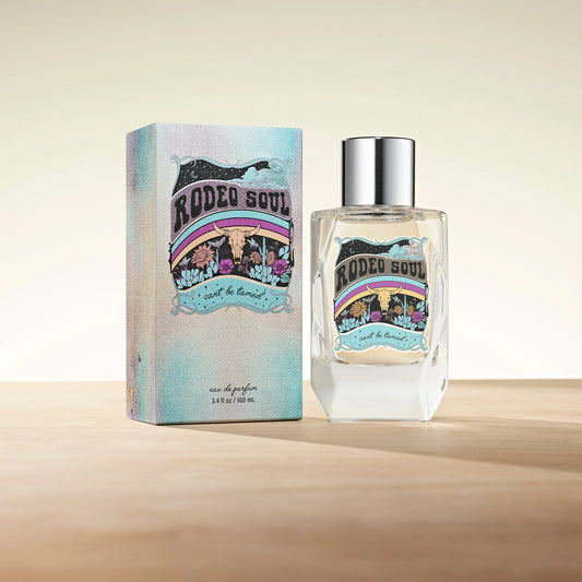 Rodeo Soul perfume bottle and carton on wood surface