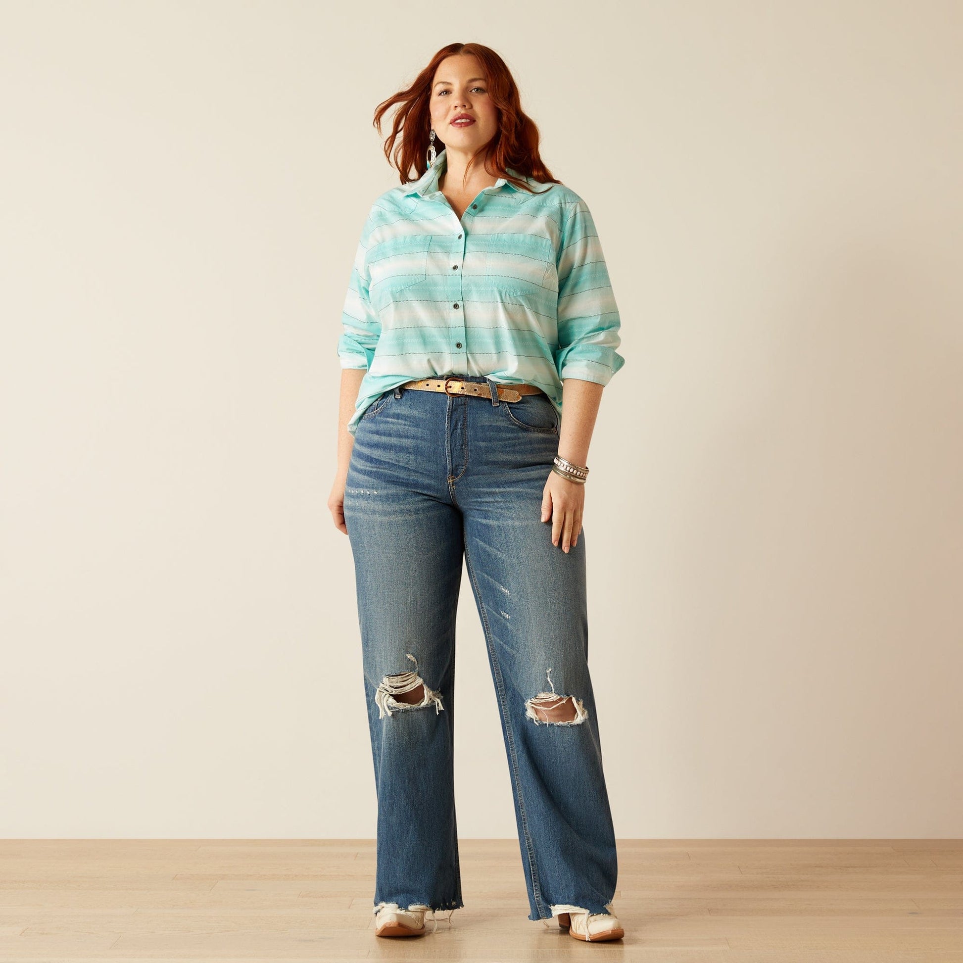 Woman in jeans and striped shirt, plus warm tones.
