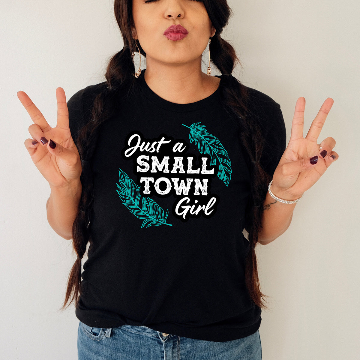 Woman in Just a Small Town Girl shirt.