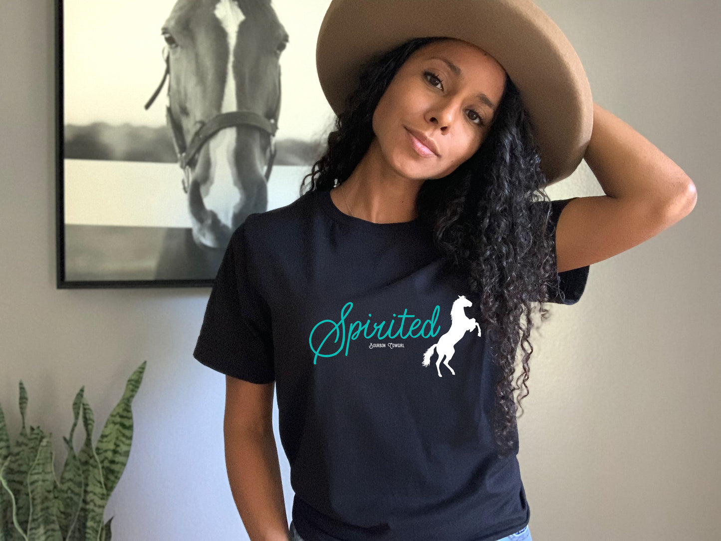 Woman wearing Spirited Tee shirt with horse logo.
