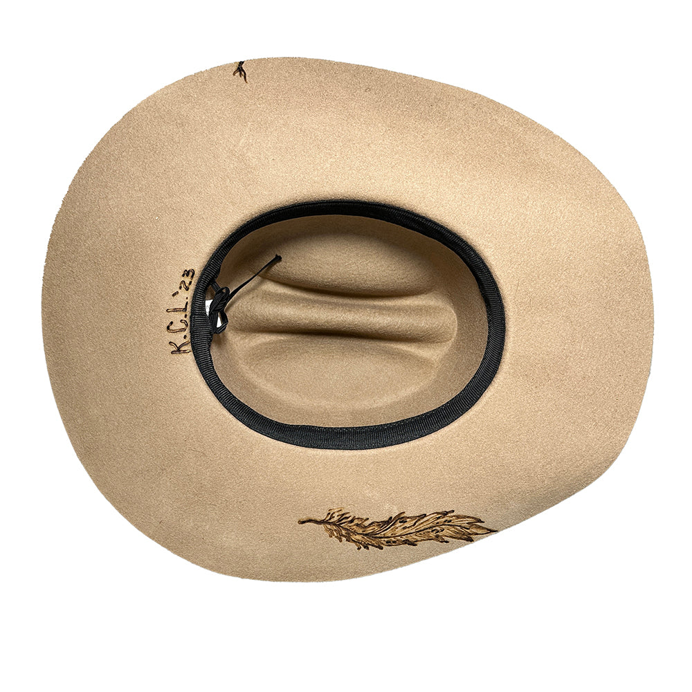 Tan cowboy hat with feather detail