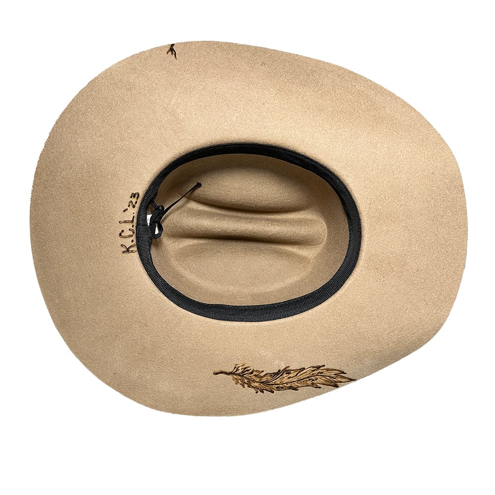 Tan cowboy hat with feather detail