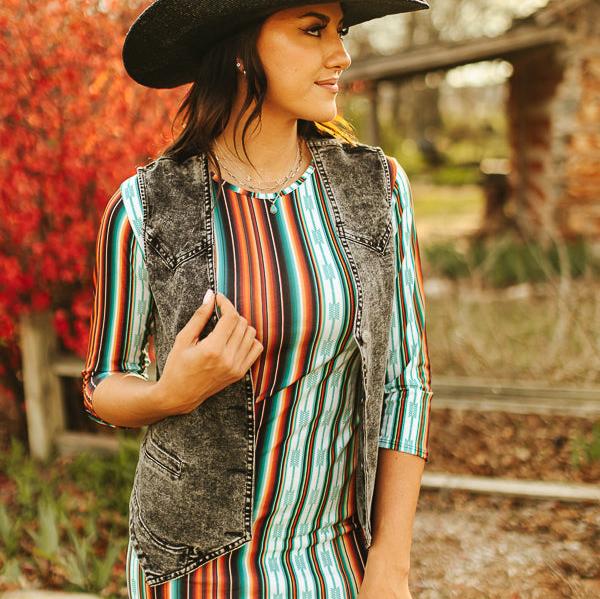 Woman in striped dress and denim vest