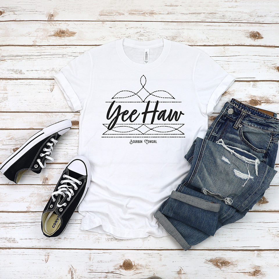 Yeehaw graphic tee with jeans and sneakers.