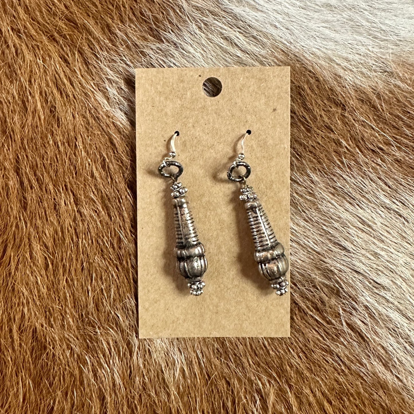 akear6 silver earrings on display