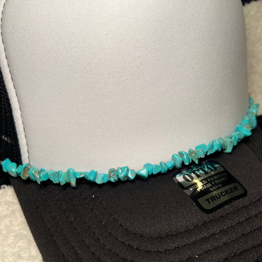 Black and white trucker hat with turquoise stone embellishment.