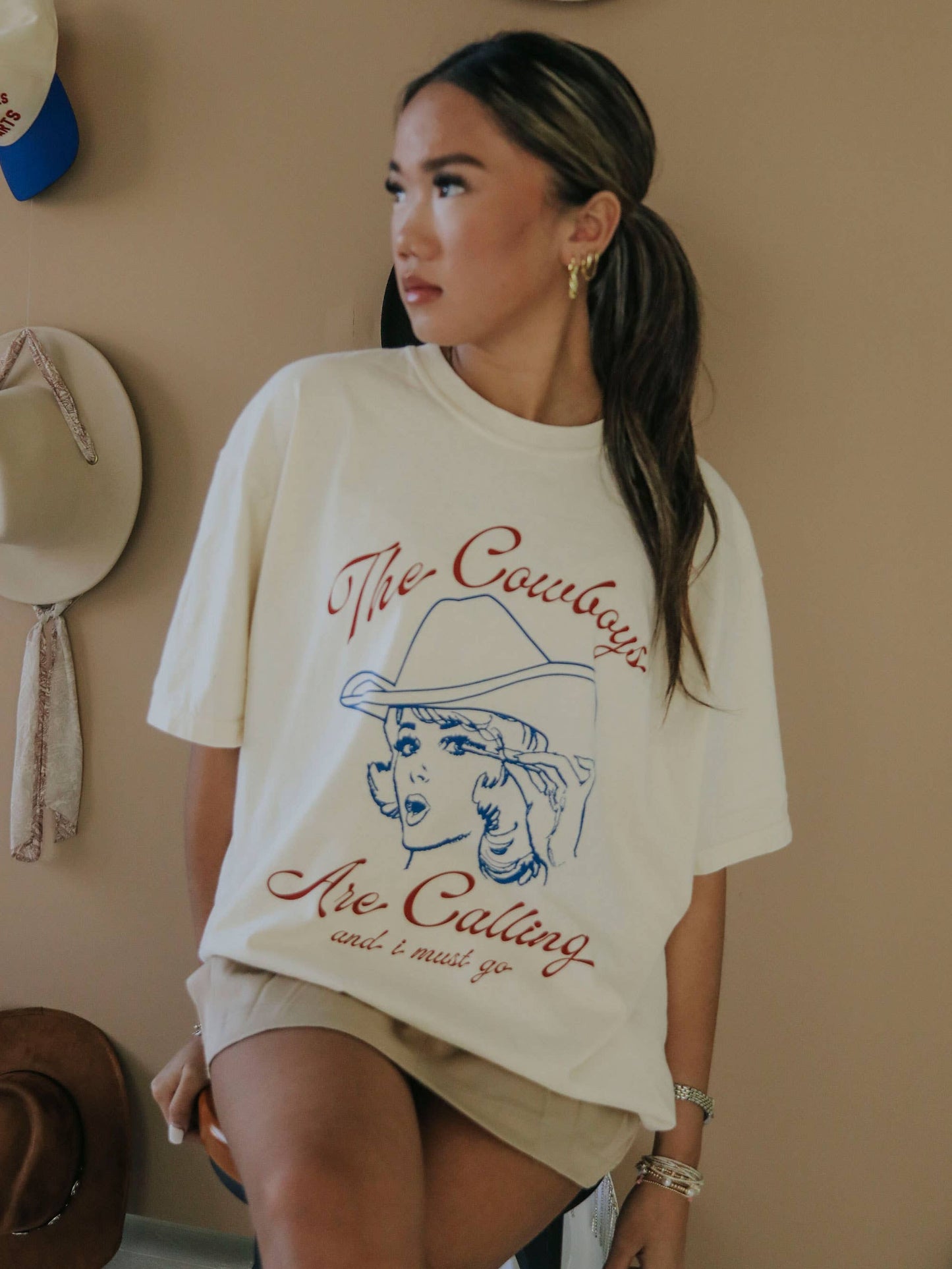 Woman wearing Cowboys graphic tee.