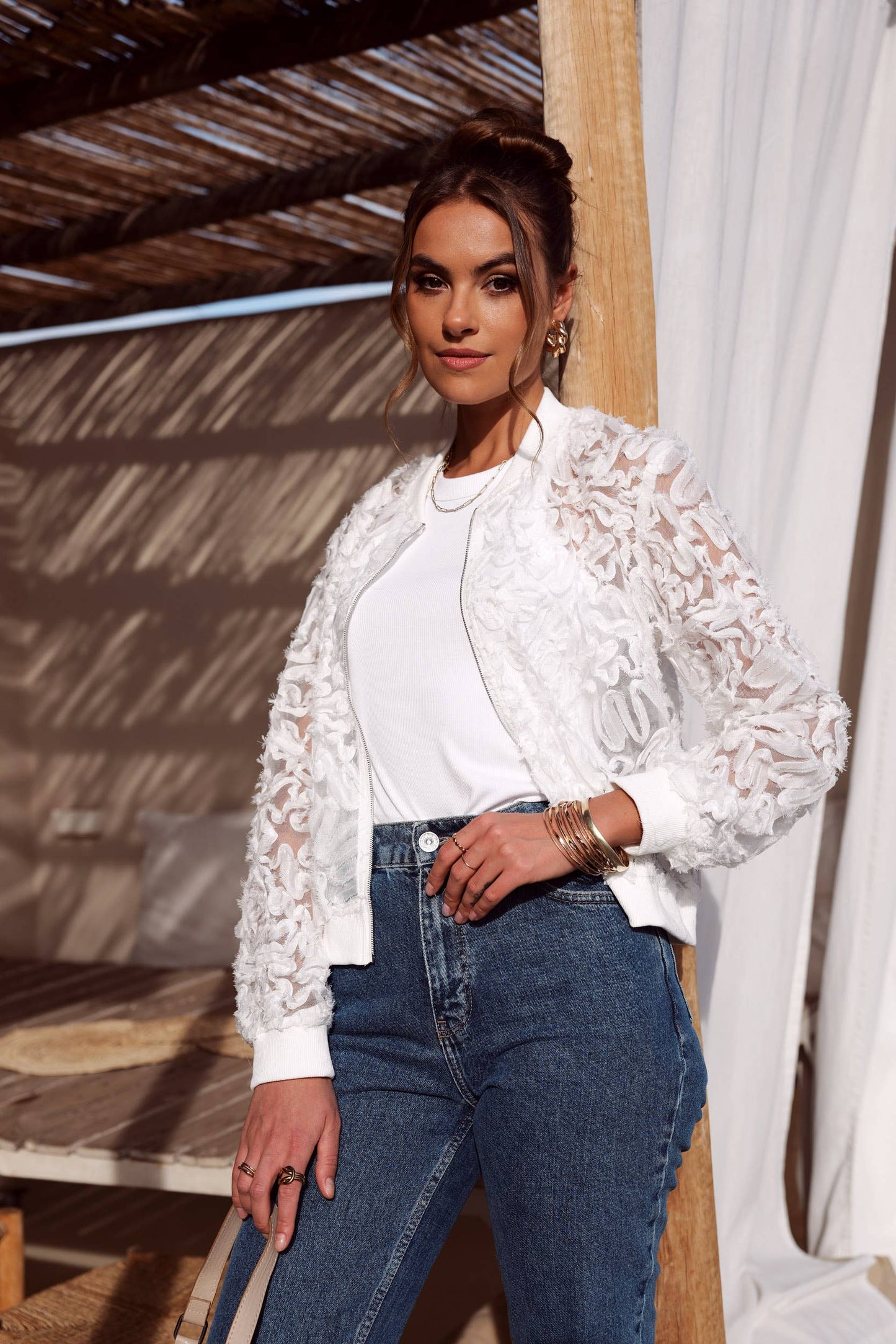 Woman in white lace jacket and jeans
