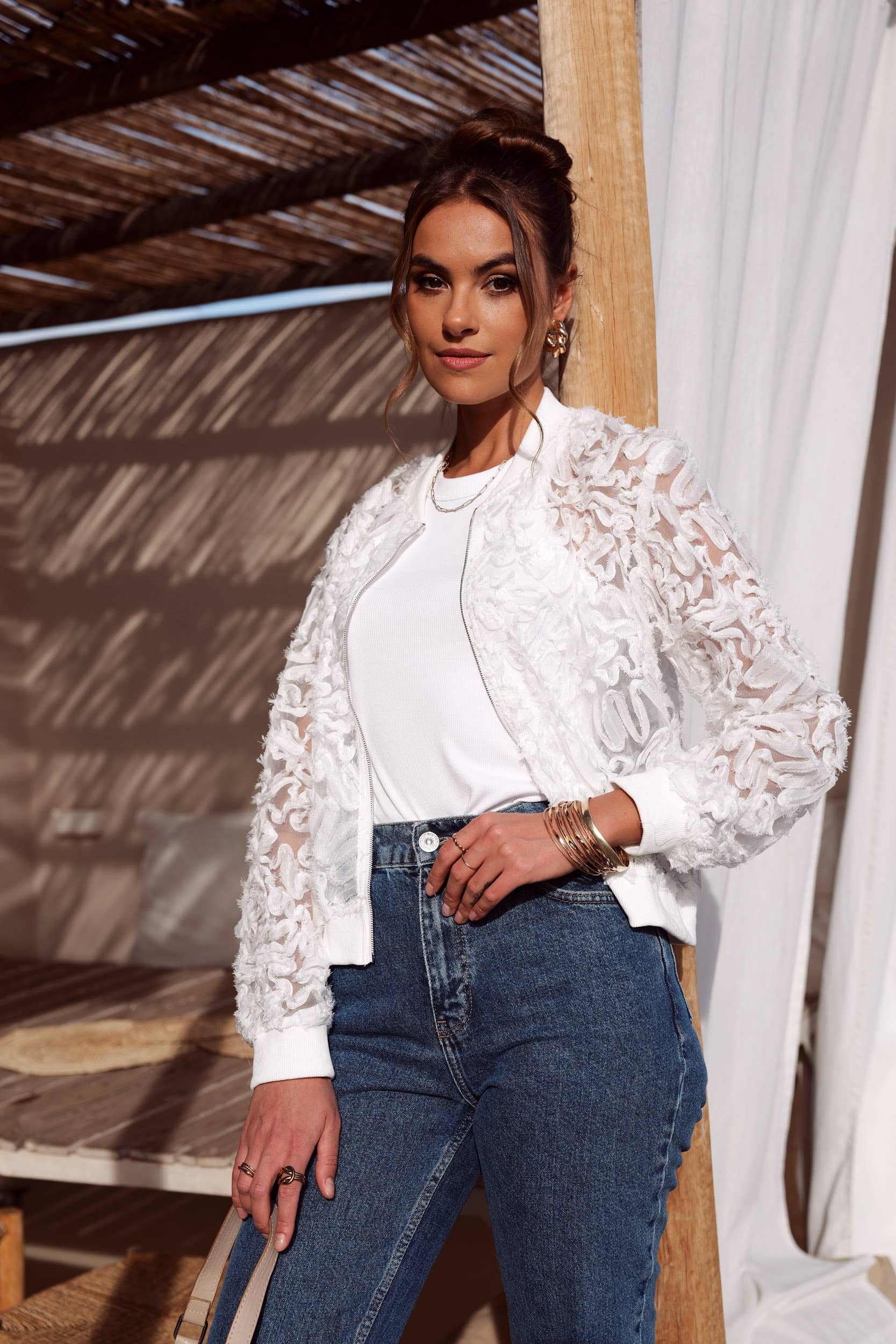 Woman in white lace jacket and jeans