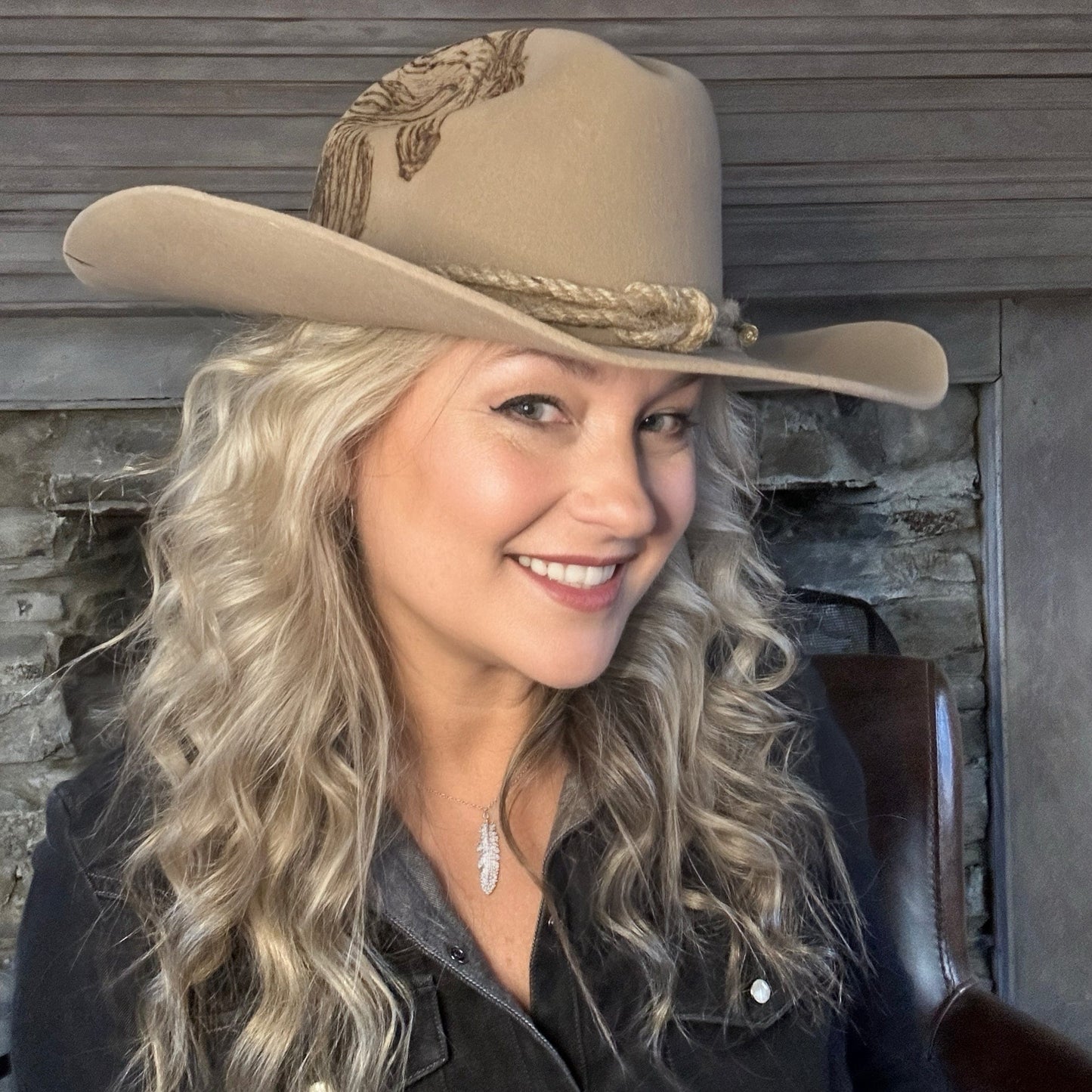 Woman smiling, wearing beige cowboy hat